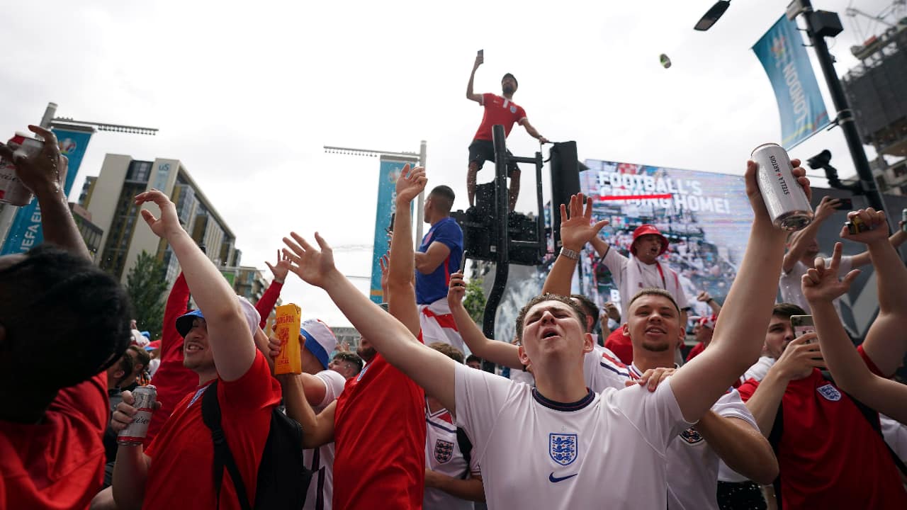 England fans react as they begin to gather, ahead of the Euro 2020 soccer championship final match between England and Italy, at Wembley Stadium. (AP Photo/Zac Goodwin)