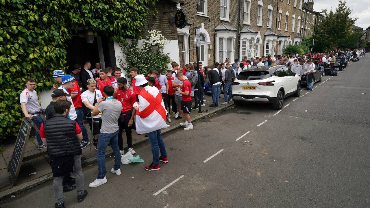 England fans queue outside the The Faltering Fullback pub in Finsbury Park, London, ahead of the Euro 2020 soccer championship final match between England and Italy, at Wembley Stadium, in London. (AP Photo/Jonathan Brady)