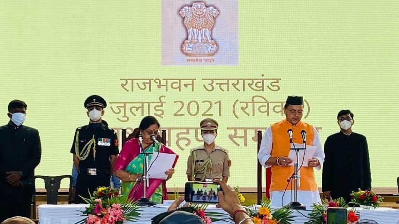 Uttarakhand Governor Baby Rani Maurya administering the oath of office to the state’s new chief minister Pushkar Singh Dhami (Image: Twitter/@arjunrammeghwal)