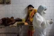 A woman leans against a stretcher holding her husband in the corridor of the emergency ward of Jawahar Lal Nehru Medical College and Hospital, during the coronavirus disease (COVID-19) outbreak, in Bhagalpur, in the eastern state of Bihar, India, July 27, 2020. REUTERS/Danish Siddiqui
