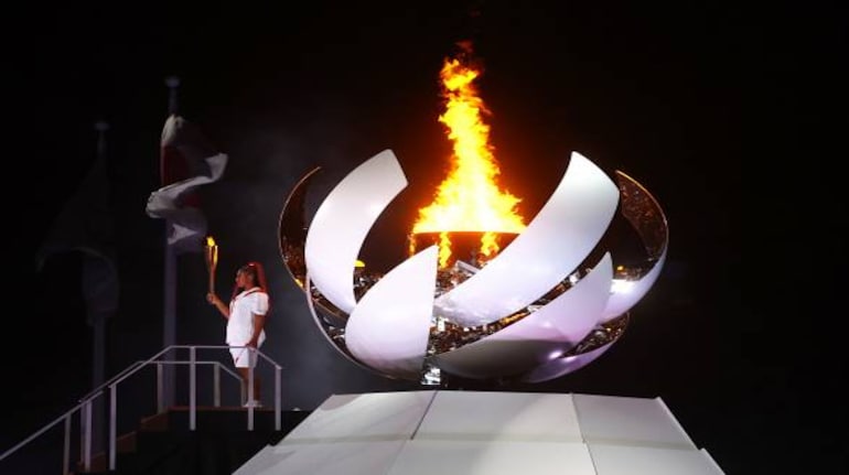 Tokyo 2020 Olympics: Naomi Osaka of Japan holds the Olympic torch after lighting the Olympic cauldron at the opening ceremony (Image Source: REUTERS/Kai Pfaffenbach) Tokyo 2020 Olympics: Naomi Osaka of Japan holds the Olympic torch after lighting the Olympic cauldron at the opening ceremony (Image Source: REUTERS/Kai Pfaffenbach)