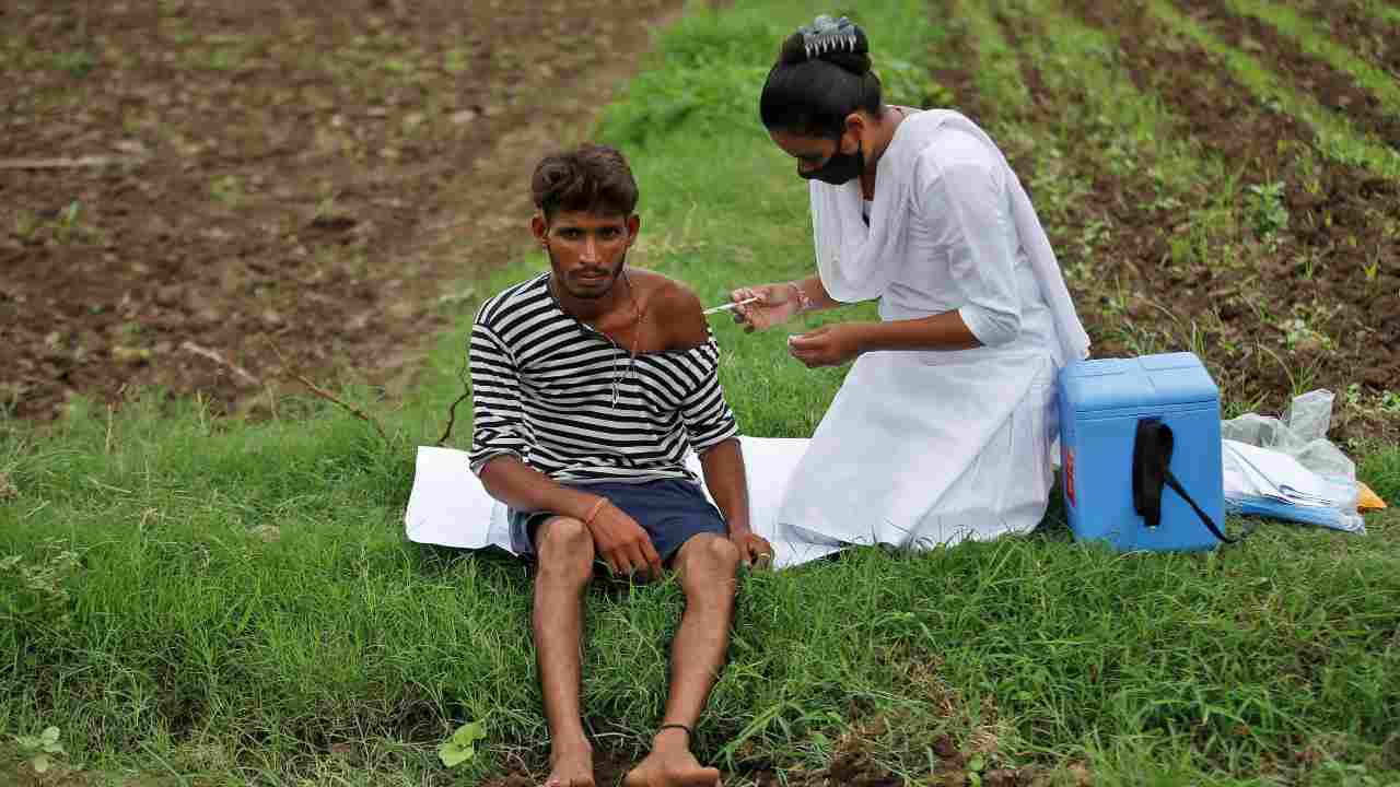 A healthcare worker gives a dose of the COVISHIELD vaccine against the coronavirus disease (COVID-19), manufactured by Serum Institute of India, to a farmer in his field, during a door-to-door vaccination drive in Banaskantha district in the western state of Gujarat. (Representative image: Reuters)