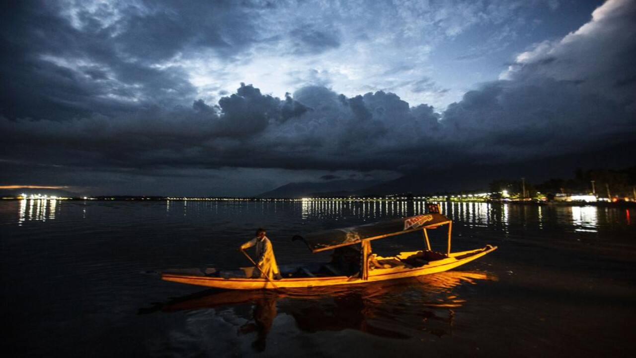 A Kashmiri boatman returns to the shore of Dal lake after day's work in Srinagar, Indian controlled Kashmir, Sunday, Aug 1, 2021. (AP Photo/Mukhtar Khan)