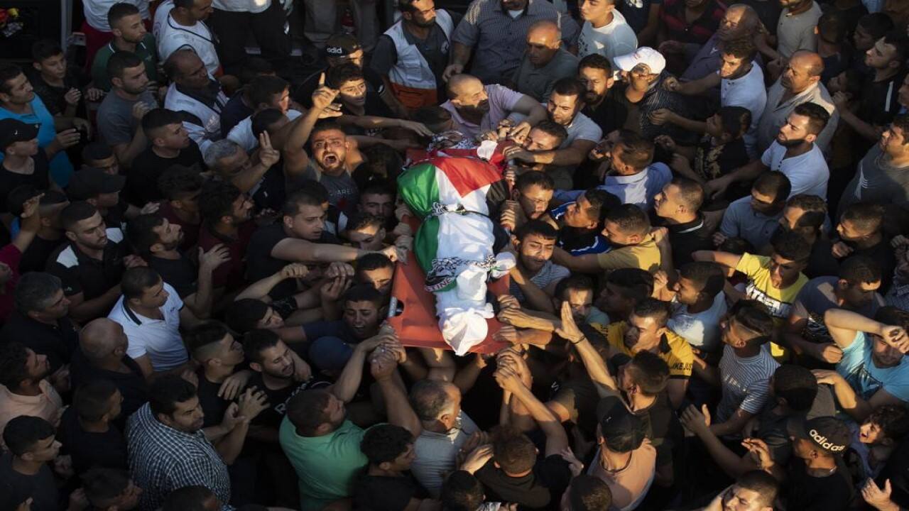 Palestinians carry the body of Imad Dwekat, 37, during his funeral in the village of Beita, south of the West Bank city of Nablus, Friday, Aug. 6, 2021. Dwekat was killed during clashes with Israeli security forces following a protest in the West Bank on Friday. (Image: AP)
