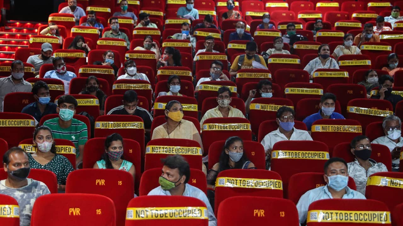 People wait to get inoculated against COVID-19 at a cinema hall in Mumbai, India, August 17. (Image: AP)