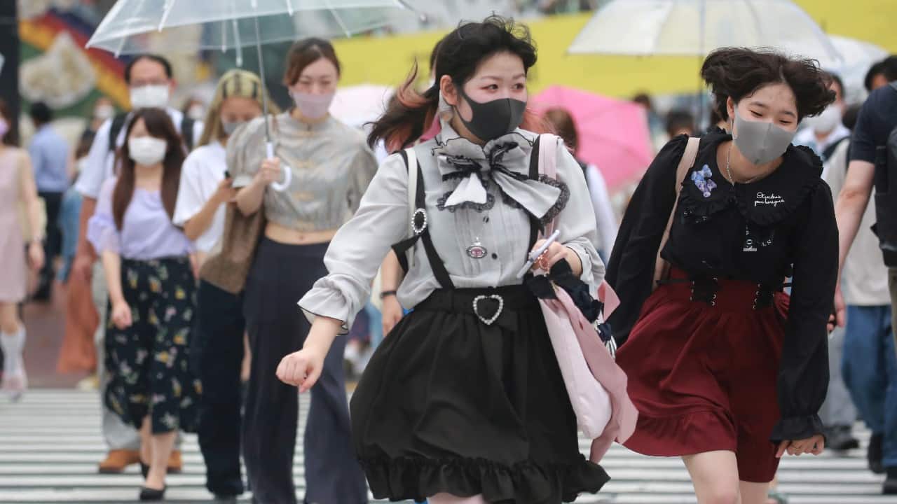 People wearing face masks to protect against the spread of the coronavirus walk on a crossing in Tokyo, August 17. Japan's coronavirus state of emergency continues through Sept. 12 rather than finishing at the end of this month as initially planned. (Image: AP)
