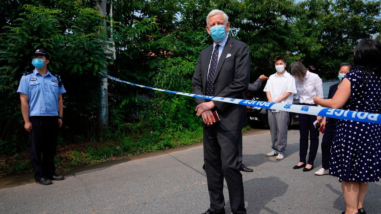 Dominic Barton, Ambassador of Canada to China stands near a barricade tape as he arrives at a detention center to meet Canadian Michael Spavor, in Dandong, China. A Chinese court has sentenced Spavor to 11 years on spying charges in case linked to Huawei. (Image: AP)