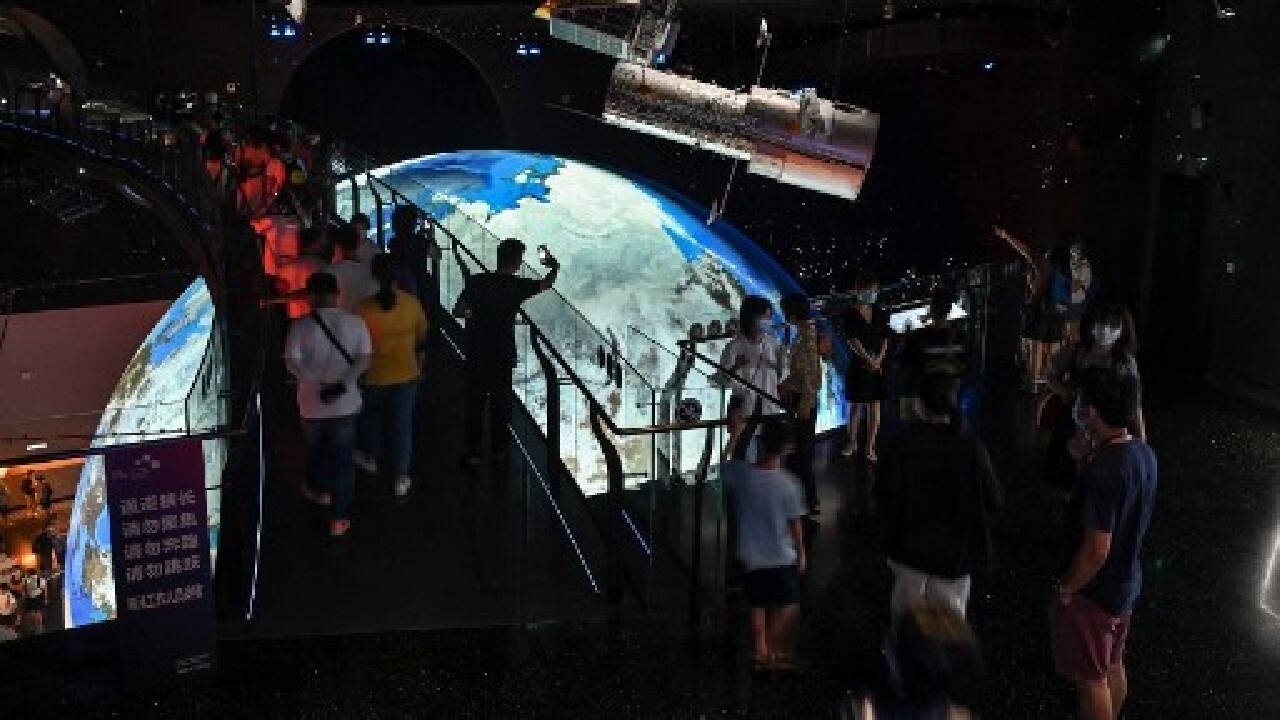 "This year we had several astronauts go to space, which is a source of pride for China," said a woman surnamed Zhou, who brought her young daughter. "I wanted my child to have some knowledge about space from a young age." (Image: AFP)