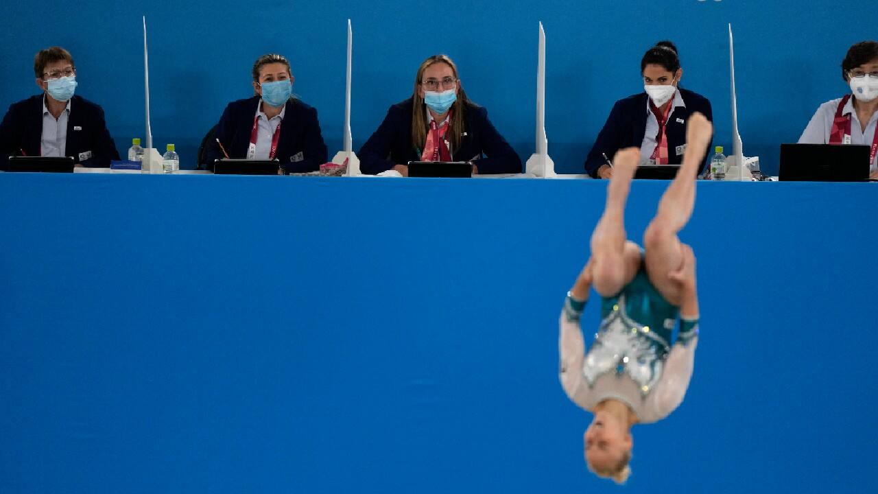 Masks, of course, are everywhere. Gymnastics judges eyed competitors carefully over top of them. (Image: AP)