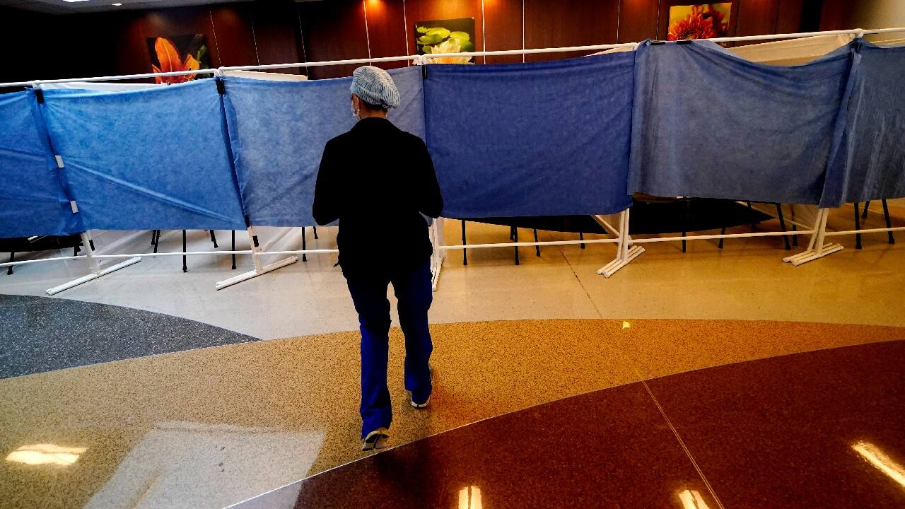 Inside Willis-Knighton, plastic sheeting separates the lobby so potential COVID-19 patients can be isolated as they are examined. The halls are filled with medical equipment and nurses and doctors in head-to-toe protective gear shuffling from one room to the next. But those busy hallways are a stark reminder that just when it seems things might get back to normal, the pandemic roared back. (Image: AP)