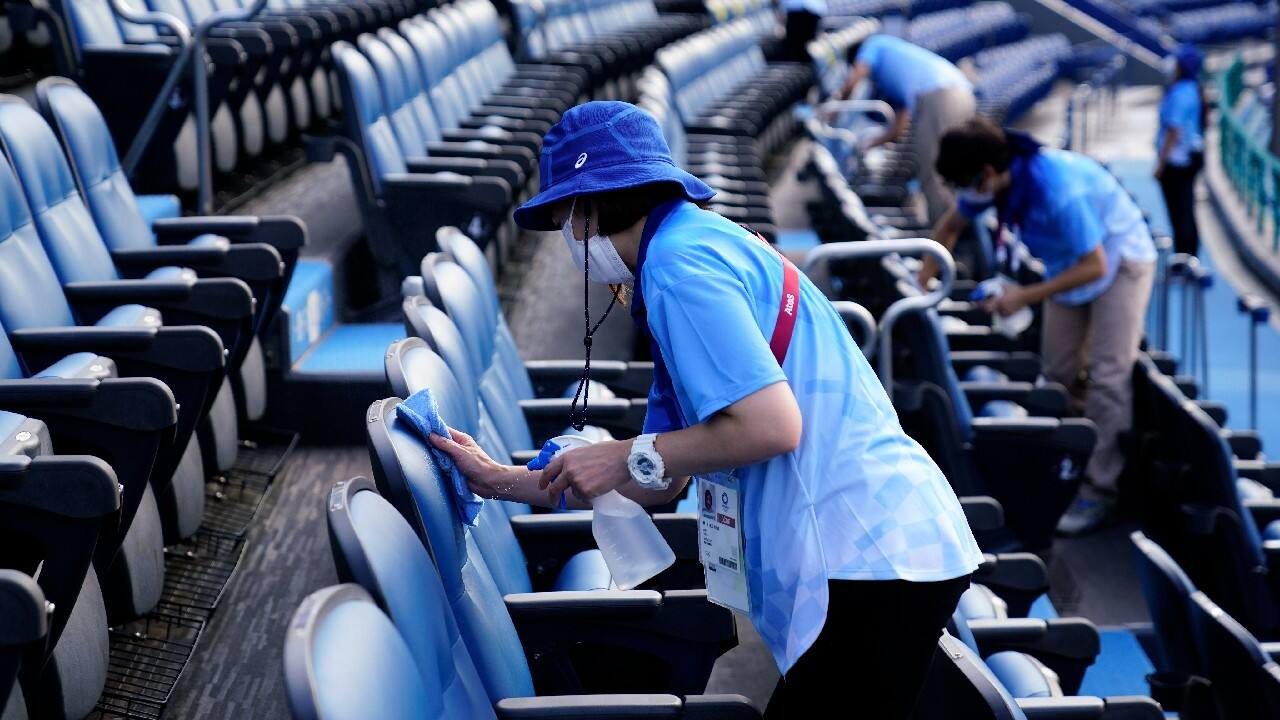 Disinfection has become an around-the-clock effort. Officials in gloves sanitize the volleyballs, wipe down the table tennis surface and spray down the corners of the boxing rings. (Image: AP)