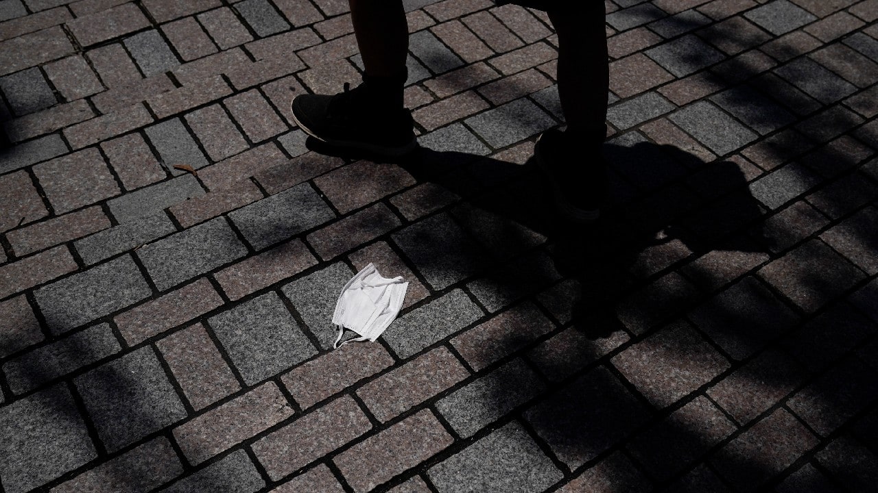 Signs of the strangeness remain even after the action stops in the form of discarded masks left on walkways and streets. (Image: AP)