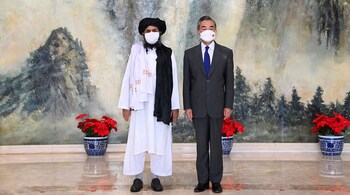 In this photo released by China's Xinhua News Agency, Taliban co-founder Mullah Abdul Ghani Baradar (left) and Chinese Foreign Minister Wang Yi pose for a photo during their meeting in Tianjin, China, on July 28, 2021. Wang met with a delegation of high-level Taliban officials as ties between them warm ahead of the US pullout from Afghanistan. (Image: Li Ran/Xinhua via AP)