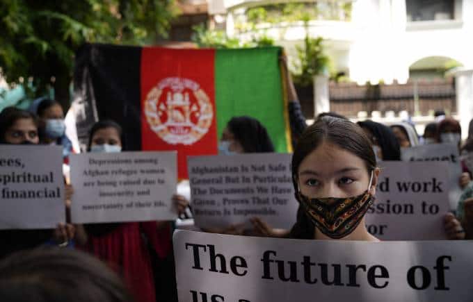 Afghans living in Delhi hold placards during a protest outside the UNHCR office (United Nation High Commissioner for Refugees) in New Delhi, India, Monday, Aug. 23, 2021. Hundreds of Afghans living in India gathered to protest against the Taliban takeover of Afghanistan and also demanded to be given refugee status in India. (AP Photo/Manish Swarup)