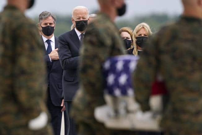 President Joe Biden, first lady Jill Biden, and Secretary of State Antony Blinken look on as as a carry team moves a transfer case with the remain of Marine Corps Cpl. Humberto A. Sanchez, 22, of Logansport, Ind., during a casualty return at Dover Air Force Base, Del., Sunday, Aug. 29, 2021, for the 13 service members killed in the suicide bombing in Kabul, Afghanistan, on Aug. 26. (AP Photo/Carolyn Kaster)