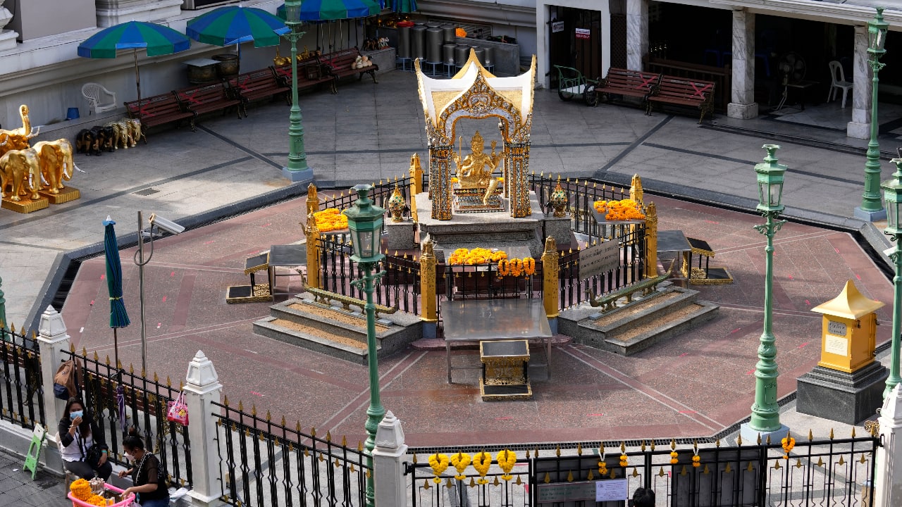 Flower vendors sit outside Erawan Shrine in Bangkok, Thailand. (AP Photo/Sakchai Lalit)