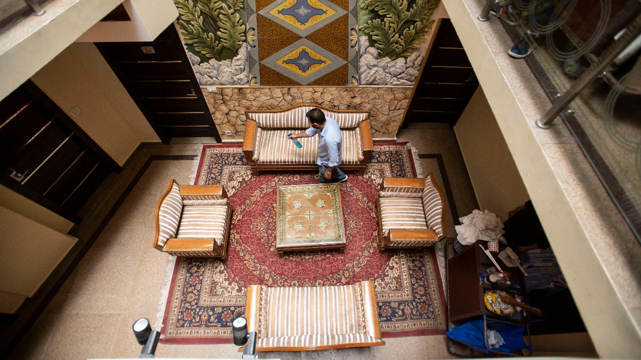 A man sanitizes the interiors of a hotel in Srinagar. (AP Photo/Mukhtar Khan)
