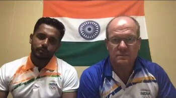 Goal scorer Harmanpreet Singh (left) and coach Graham Reid speak to the media from Tokyo on Thursday, August 5, 2021.