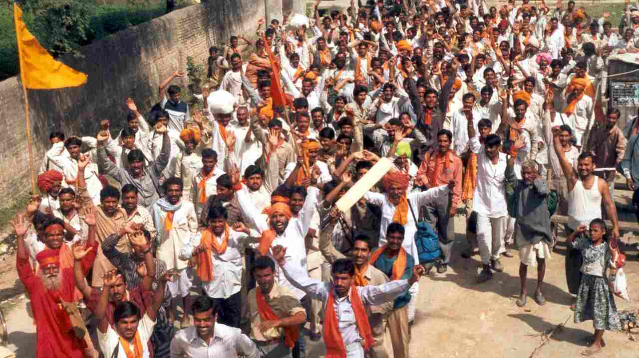 Hindu devotees raise their arms in support of Ram Mandir, while shouting slogans in a street in the city of Ayodhya in Uttar Pradesh on February 28, 2002. (Image: Reuters)
