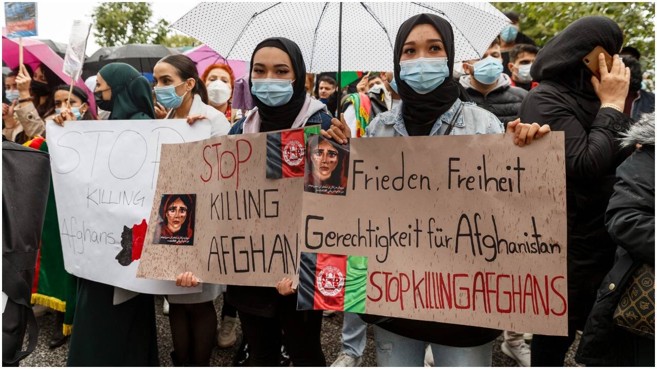 Women hold signs reading "Stop killing Afghans" and "Peace, Freedom, Justice for Afghanistan" during a demonstration for the reception of threatened people from Afghanistan, in Hamburg, Germany, Sunday Aug. 22, 2021. (Image: AP)