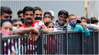 People wait in a queue to receive the vaccine against coronavirus disease (COVID-19) outside a shopping mall in Mumbai, India, August 11, 2021. REUTERS/Francis Mascarenhas