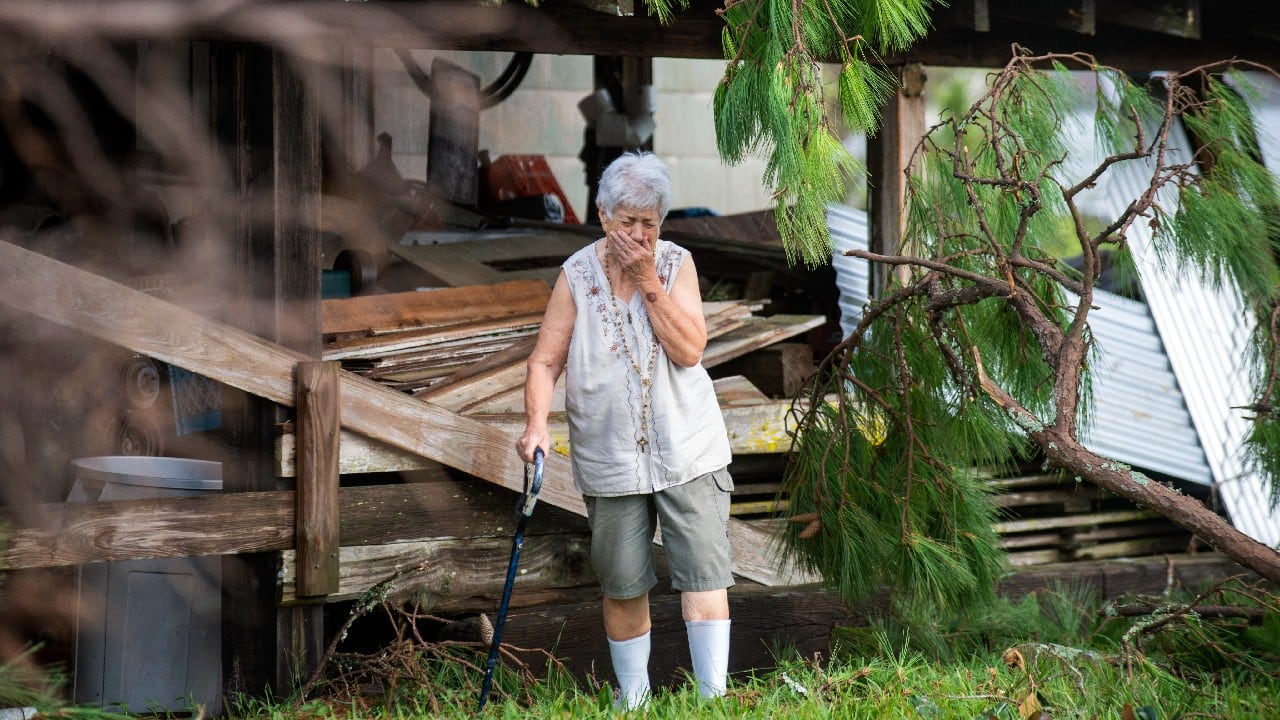 Surveying the damage for the first time, Sharon Orlando tries to hold back tears on the morning after Hurricane Ida hit her Destrehan, La., home on August 30. (Image: AP)
