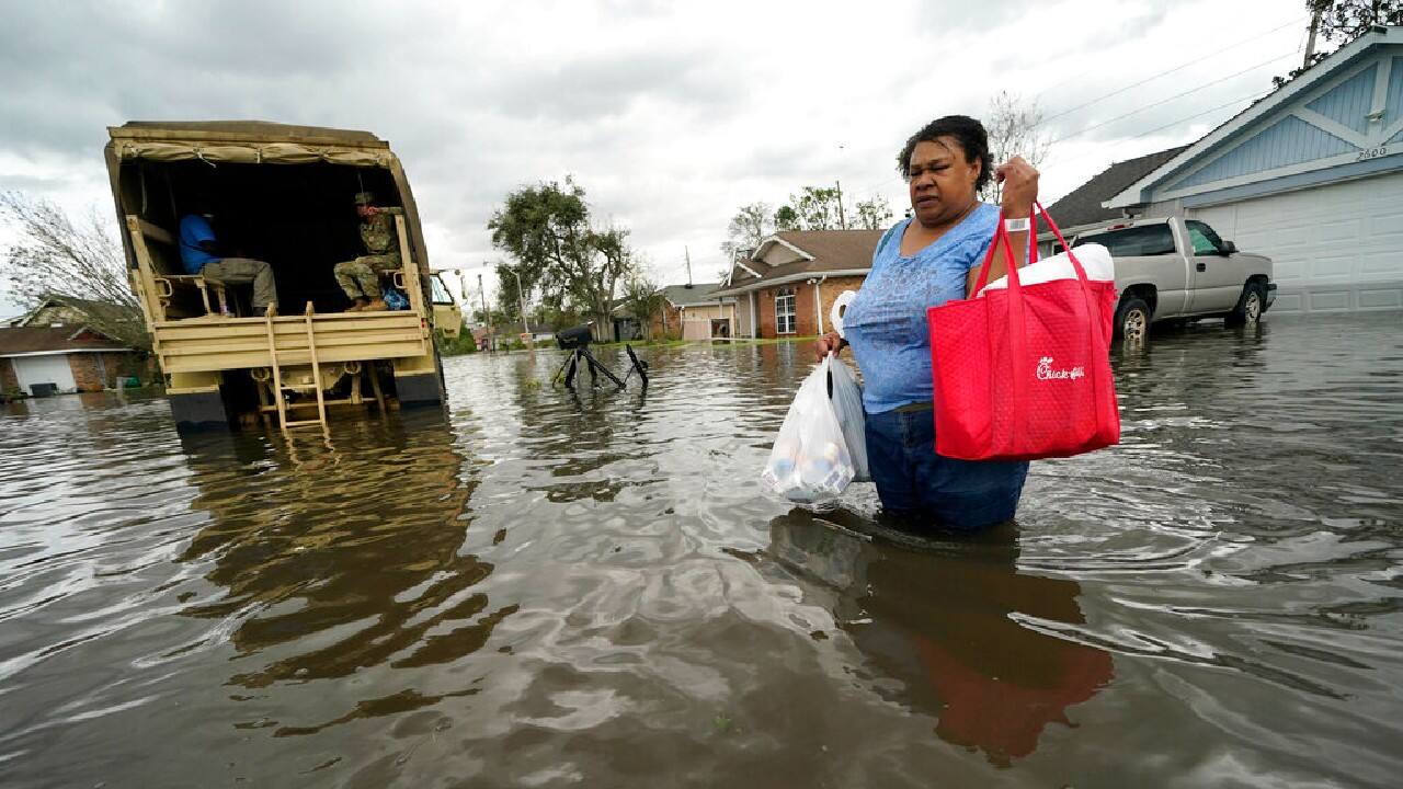 Jerilyn Collins returns to her destroyed home with the assistance of a Louisiana National Guard high-water vehicle to retrieve medicine for herself and her father, and a few possessions, after she evacuated from rising floodwater in the aftermath of Hurricane Ida in LaPlace, La., August 30. (Image: AP)