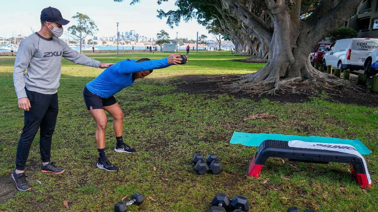 Personal trainers have turned a waterfront park into an outdoor gym to get around Sydney’s pandemic lockdown restrictions. (Image: AP)