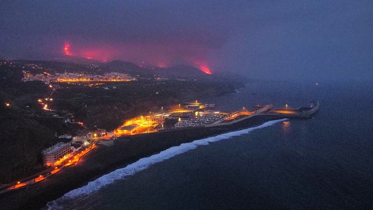 Lava is seen and smoke rises following the eruption of a volcano, in the Port of Tazacorte, on the Canary Island of La Palma, Spain. (Image: Reuters) Lava is seen and smoke rises following the eruption of a volcano, in the Port of Tazacorte, on the Canary Island of La Palma, Spain. (Image: Reuters)