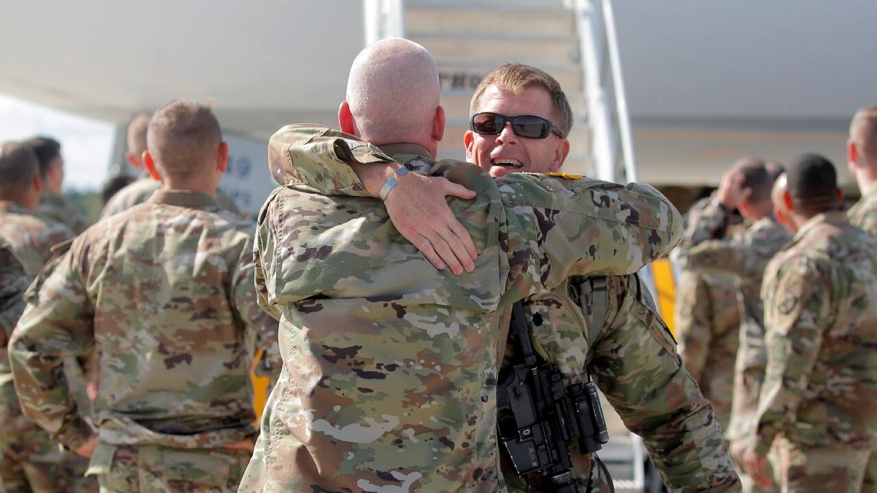 A soldier with the 4th Battalion, 31st Infantry Regiment, 2nd Brigade Combat Team of the 10th Mountain Division, is embraced upon returning home from deployment in Afghanistan, at Fort Drum, New York, U.S., September 6. (Image: Reuters)