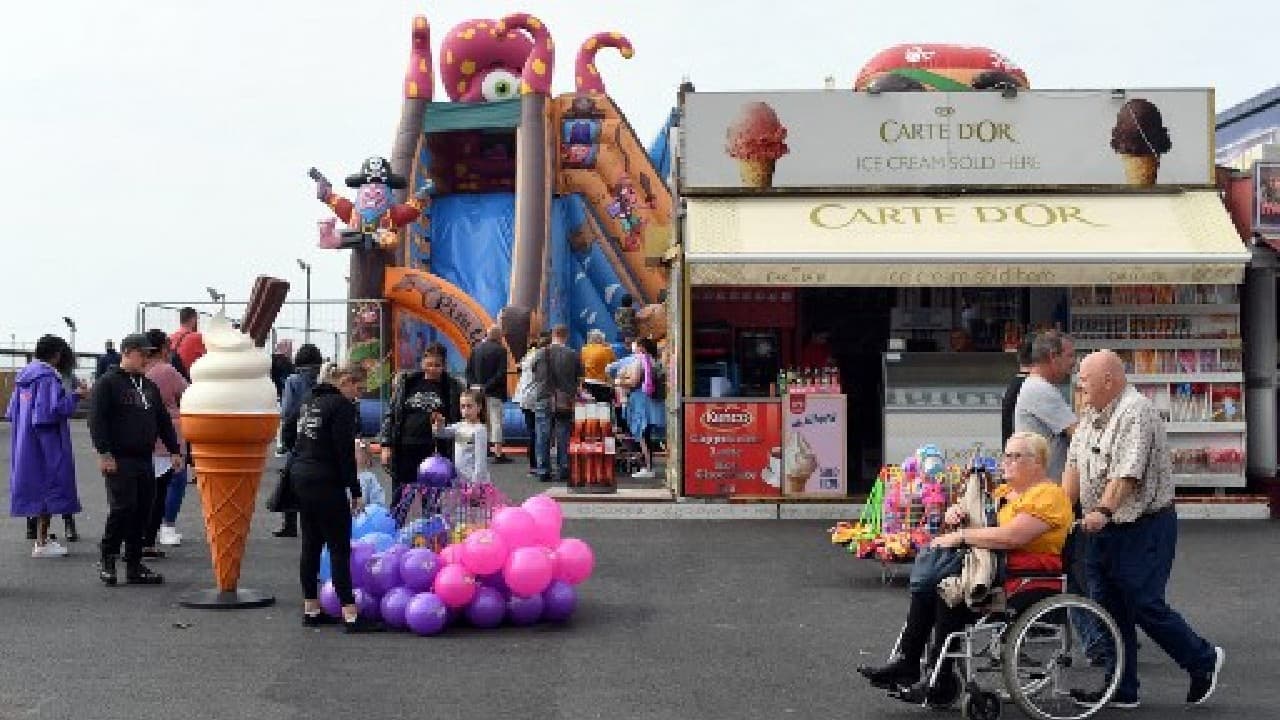 Tourists thronged its promenade on Illuminations switch-on day earlier this month, to explore its tower, piers, theme park, beach, amusement arcades and shops selling fish and chips, ice cream and local sweet treat Blackpool rock. (Image: AFP) , Domestic tourism boom gives UK seaside new lease of life amid COVID-19 blues, The World Live Breaking News Coverage & Updates IN ENGLISH