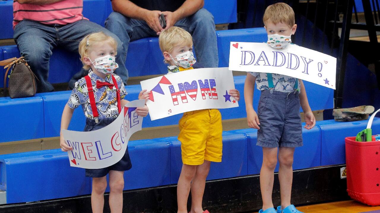 Children hold signs while greeting soldiers with the 4th Battalion, 31st Infantry Regiment, 2nd Brigade Combat Team of the 10th Mountain Division, upon their return home from deployment in Afghanistan, at Fort Drum, New York, U.S., September 6. (Image: Reuters)