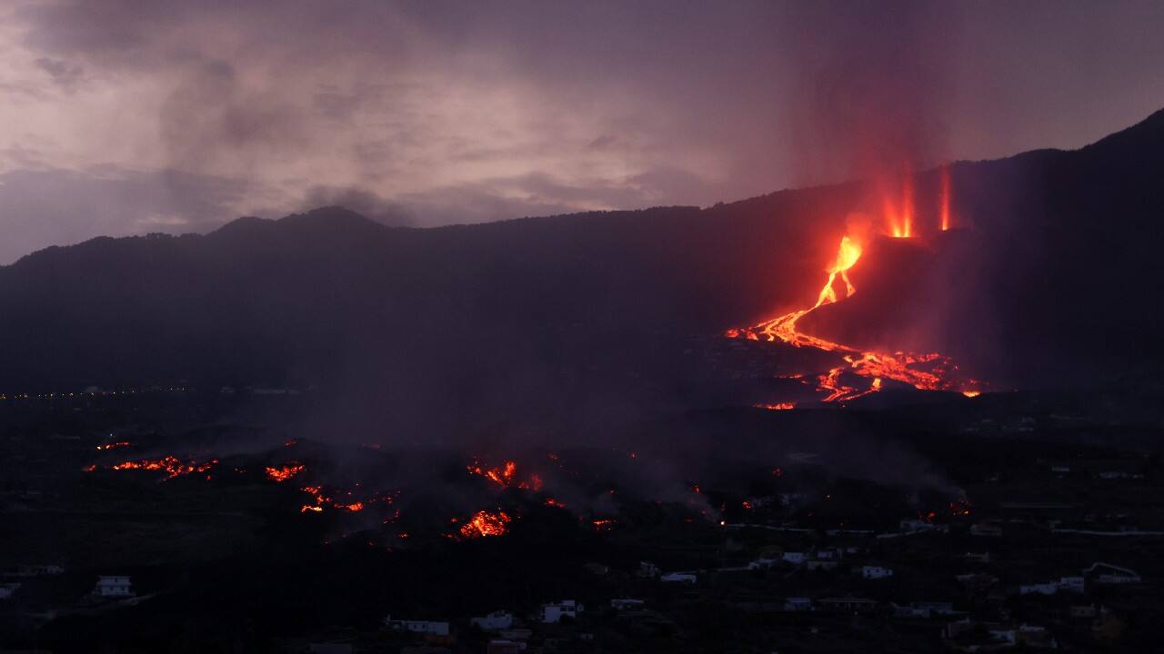 Lava flows and smoke rises during sunrise following the eruption of a volcano on the Canary Island of La Palma, in Todoque, Spain. (Image: Reuters) Lava flows and smoke rises during sunrise following the eruption of a volcano on the Canary Island of La Palma, in Todoque, Spain. (Image: Reuters)