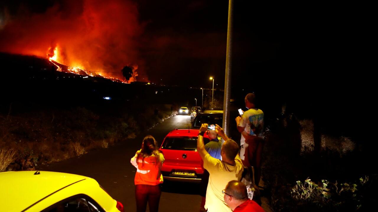 Residents watch lava following the eruption of a volcano in the Cumbre Vieja national park at El Paso, on the Canary Island of La Palma. (Image: Reuters)