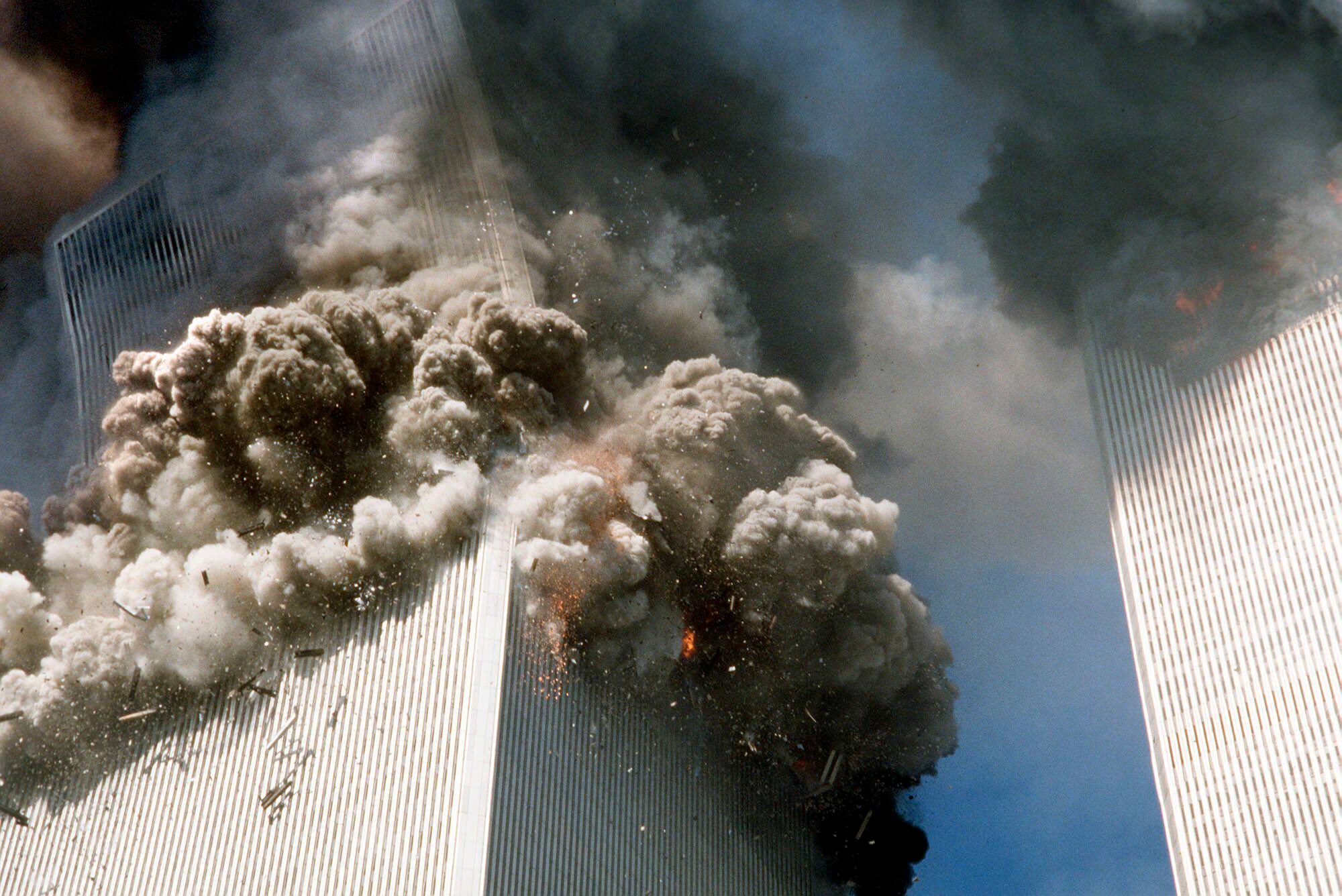 FILE - In this Sept. 11, 2001, file photo, the south tower of the World Trade Center, left, begins to collapse after a terrorist attack on the landmark buildings in New York. (AP Photo/Gulnara Samoilova, File)
