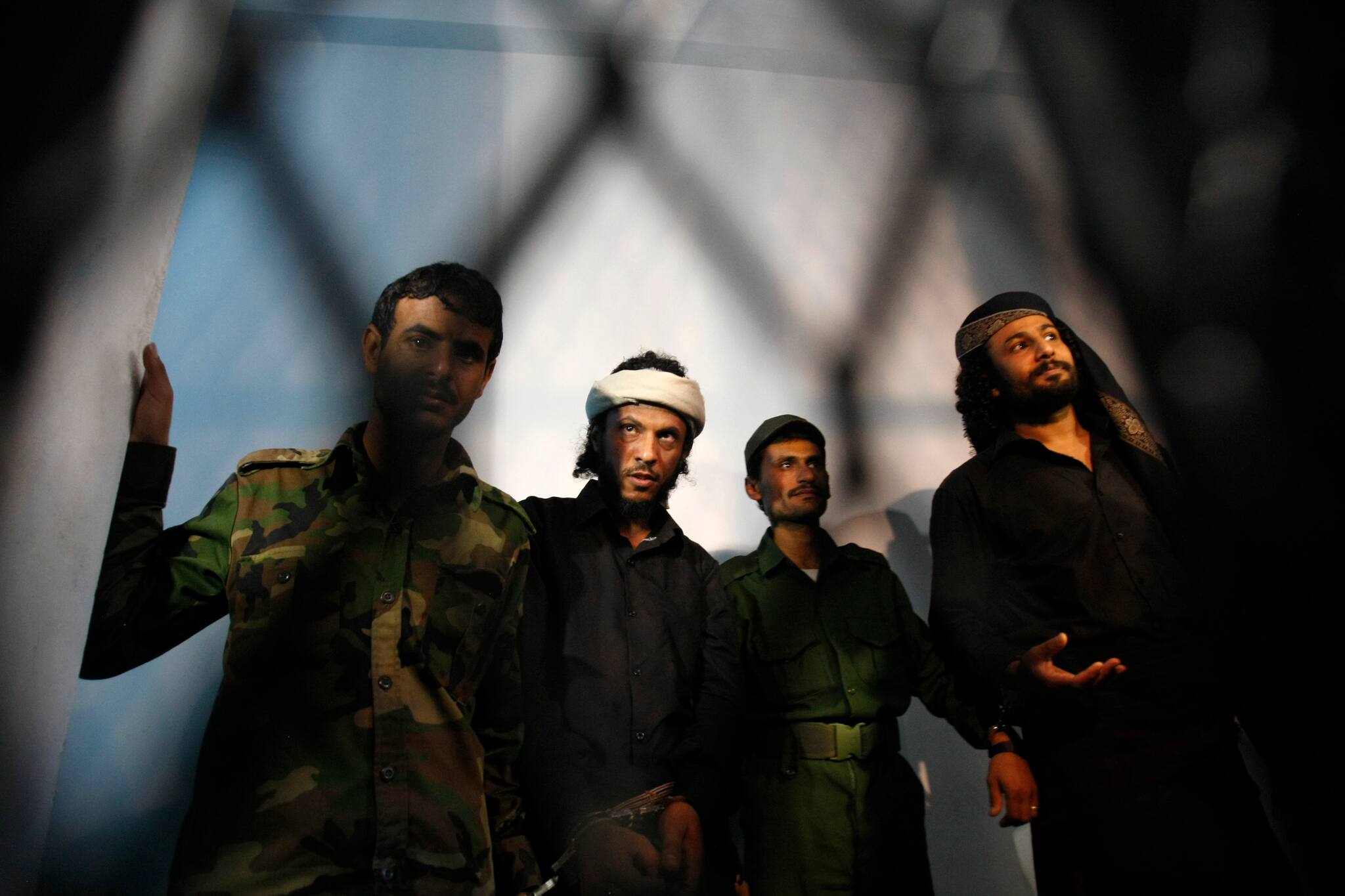 FILE - In this April 22, 2014 file photo, a group of suspected al-Qaida militants accused in the killing of an army general in a suicide bombing, stand trial at a state security court in Sanaa, Yemen. Over the past decade, even as it used Yemen as a base for international attacks, al-Qaida in the Arabian Peninsula has often clashed with the military and security forces, carrying out attacks and withstanding crackdowns even as it sought to weave itself into Yemeni society. (AP Photo/Hani Mohammed, File)