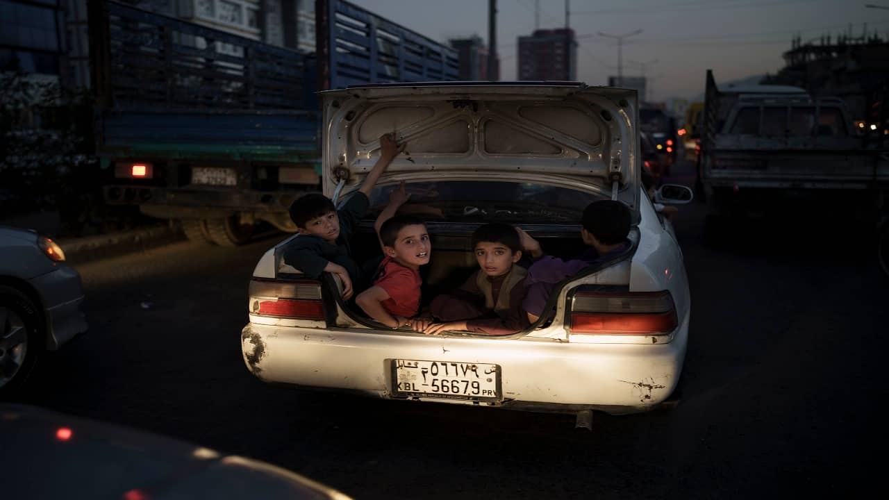 Afghan boys ride in the trunk of a car in Kabul, Afghanistan, Sunday, Sept. 26, 2021. (AP Photo/Felipe Dana)
