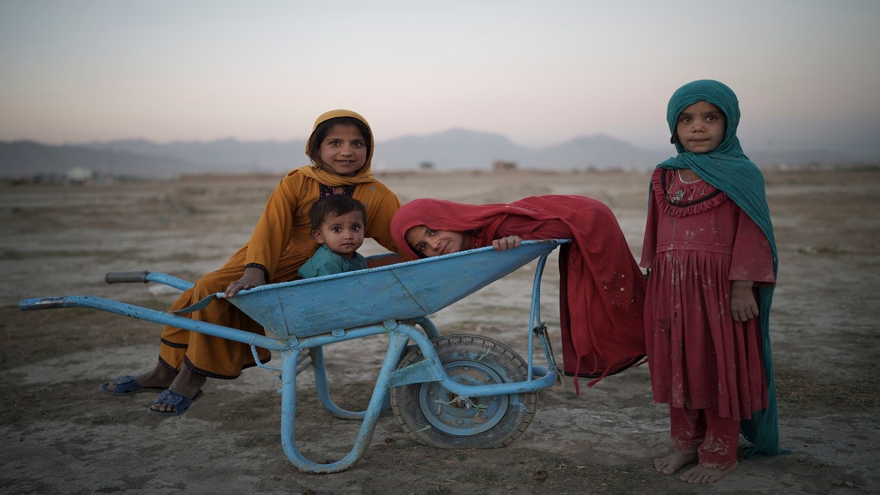 Children pose for a photo as they play in a camp for internally displaced people in Kabul, Afghanistan. (AP Photo/Felipe Dana)