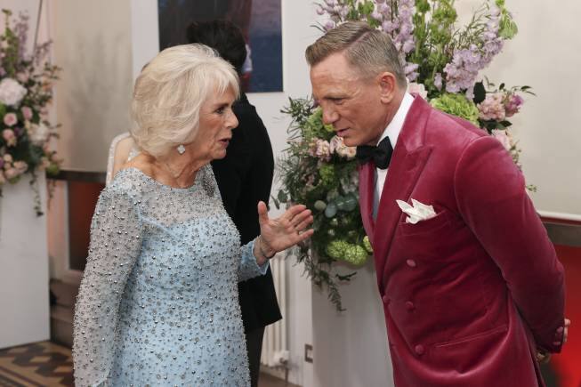 Britain's Camilla, Duchess of Cornwall, left, speaks to British actor Daniel Craig, as they attend the World premiere of the new film from the James Bond franchise 'No Time To Die', in London, Tuesday, Sept. 28, 2021. (Chris Jackson/Pool Photo via AP)