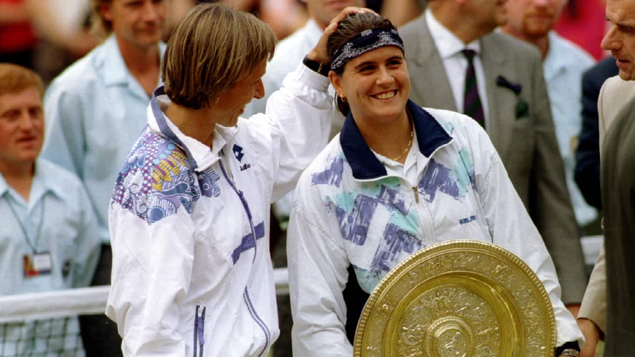 Spain's Conchita Martinez is patted on the head by Martina Navratilova of the US after her victory in the Ladies Singles final at the Wimbledon tennis championships in England July 2, 1994. Martinez won the final 6-4 3-6 6-3. SCANNED FROM NEGATIVE REUTERS/Andrew Wong