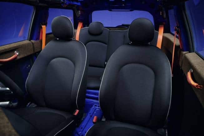 Mini Strip: The seats are kitted out in a knitted fabric, while the dashboard topper pad, door shoulders and parcel shelf are fashioned out of recycled cork. The terrazzo-esque black and blue floor mats showcase the heterogeneous composition of the materials used in their manufacturing.