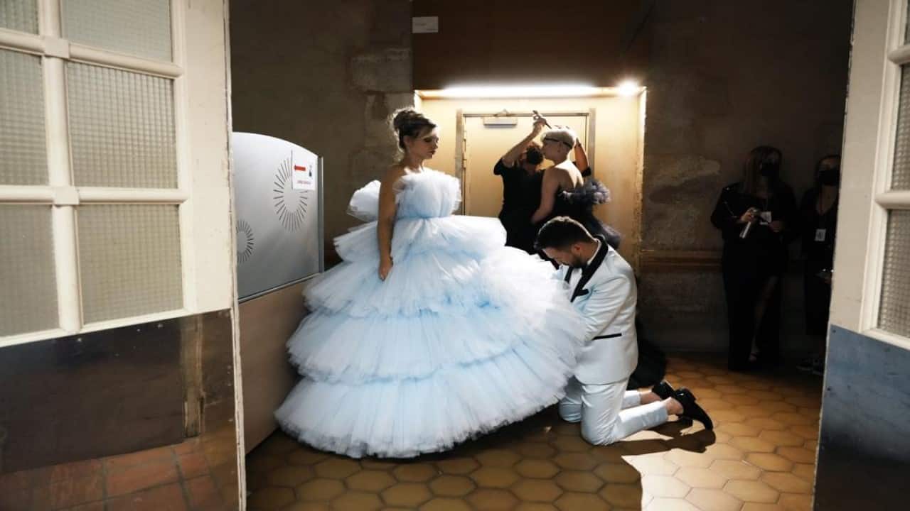 A model, who is an amputee, has her dress adjusted prior to the 'Victoire, on defile!' (Victory, we walk!) fashion show, at the Hotel des Invalides in Paris, Wednesday, Sept. 29 2021. A new collection by Italian designer Fabio Porlod will feature female amputees and women who have been injured. (AP Photo/Thibault Camus) A model, who is an amputee, has her dress adjusted prior to the 'Victoire, on defile!' (Victory, we walk!) fashion show, at the Hotel des Invalides in Paris, Wednesday, Sept. 29 2021. A new collection by Italian designer Fabio Porlod will feature female amputees and women who have been injured. (AP Photo/Thibault Camus)