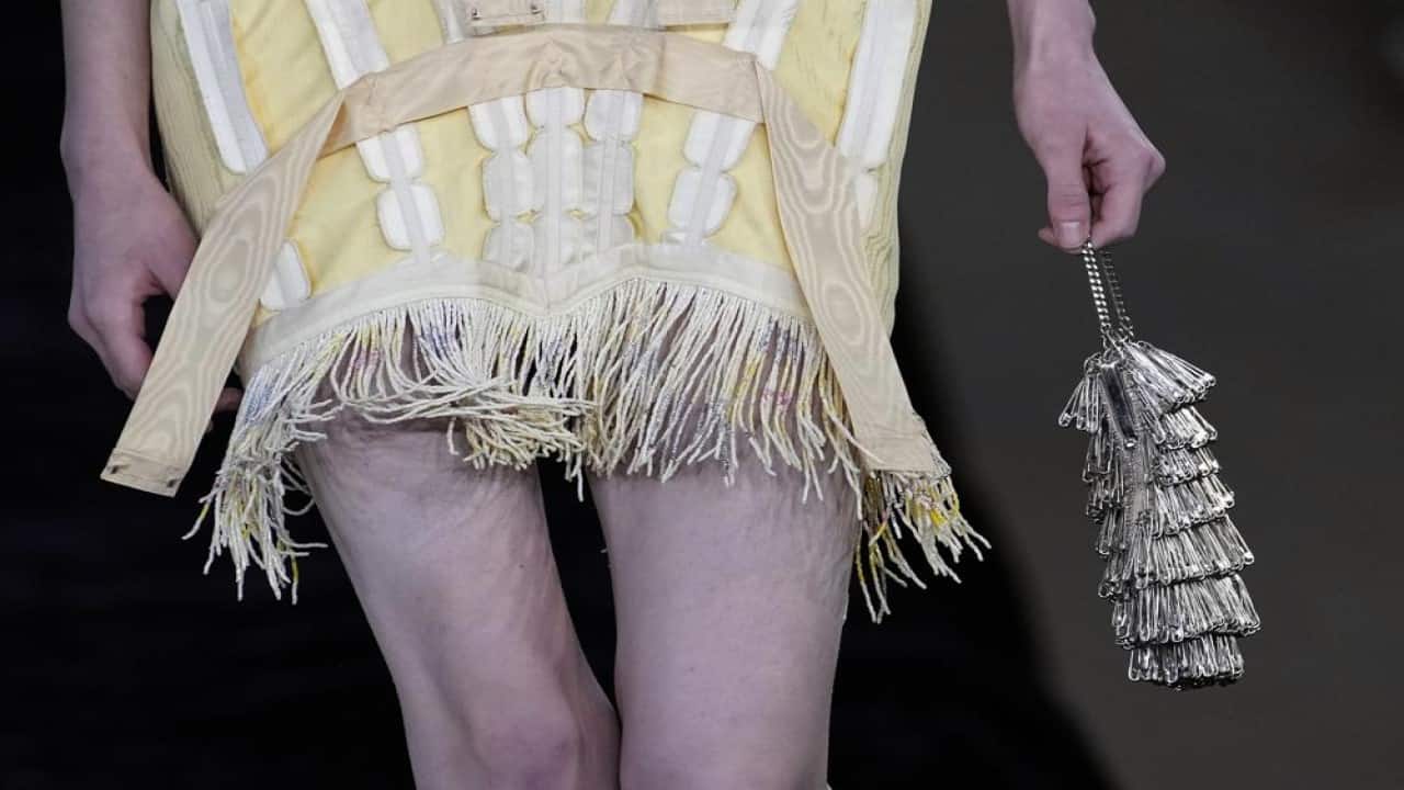 A model wears a creation for Acne Studios Spring-Summer 2022 ready-to-wear fashion show Wednesday, Sept. 29, 2021, in Paris. (AP Photo/Christophe Ena) A model wears a creation for Acne Studios Spring-Summer 2022 ready-to-wear fashion show Wednesday, Sept. 29, 2021, in Paris. (AP Photo/Christophe Ena)