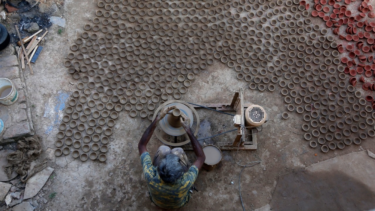 A potter makes earthen lamps ahead of Diwali, the festival of lights, in Ahmedabad, India, October 22. (Image: AP)