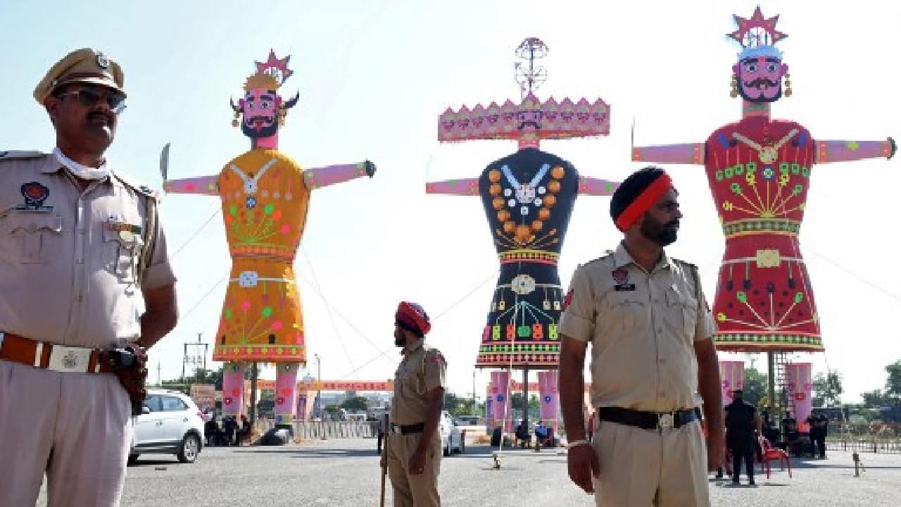 Every year on this day, effigies of Ravana are burnt. Policemen stand guard near the effigies of demon king Ravana, his son Meghnath and brother Kumbhkaran before they are set alight to mark the Hindu festival of Dussehra in Amritsar. (Image: AFP)