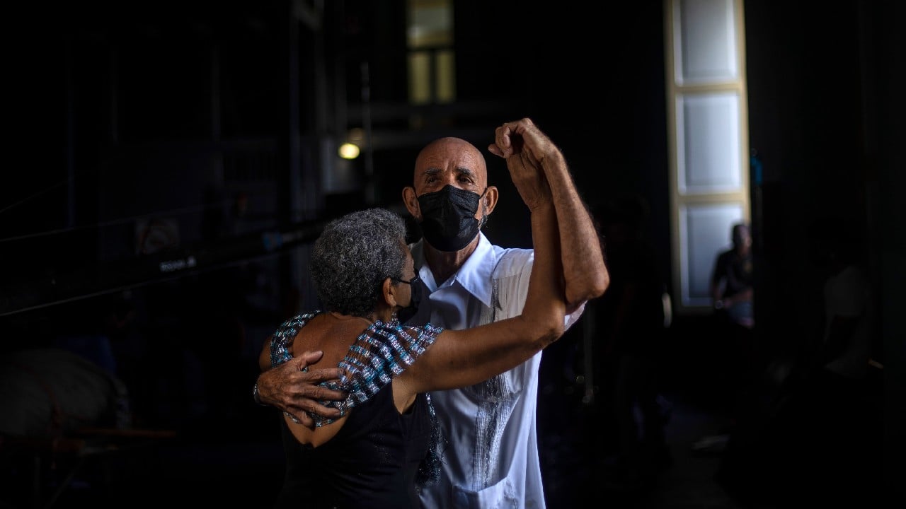 “It was very hard to be for a year and a half without being able to go out to the recreation center to dance,” says Joaquin Bruzon. “Sometimes during the quarantine at home we would dance to try to improve our spirits.” Now, once again, the Failde Orchestra of Matanzas, Cuba, can perform danzóns like “El Naranjero” and “Cuba Libre,” “A La Habana me Voy” and “Nievecita.” And once again, Bruzon and his wife, Milagros Cousett, can glide across the dance floor. (Image: AP) “It was very hard to be for a year and a half without being able to go out to the recreation center to dance,” says Joaquin Bruzon. “Sometimes during the quarantine at home we would dance to try to improve our spirits.” Now, once again, the Failde Orchestra of Matanzas, Cuba, can perform danzóns like “El Naranjero” and “Cuba Libre,” “A La Habana me Voy” and “Nievecita.” And once again, Bruzon and his wife, Milagros Cousett, can glide across the dance floor. (Image: AP)