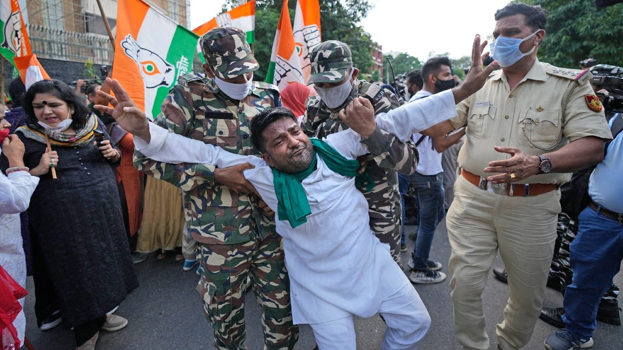 Paramilitary force soldiers detain an activist of Congress party's youth wing protesting against Sunday's killing of four farmers in Uttar Pradesh state after being run over by a car owned by India's junior home minister in New Delhi, October 4. (Image: AP)