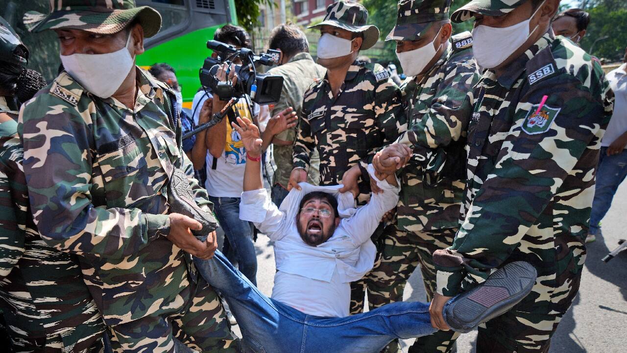 Paramilitary force soldiers detain an activist of Congress party's youth wing protesting against Sunday's killing of four farmers in Uttar Pradesh state after being run over by a car owned by India's junior home minister in New Delhi, October 4. (Image: AP)