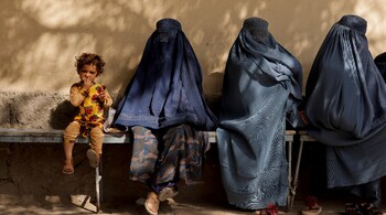 A girl sits with women wearing burqas outside a hospital in Kabul, Afghanistan October 5. (Image: Reuters)