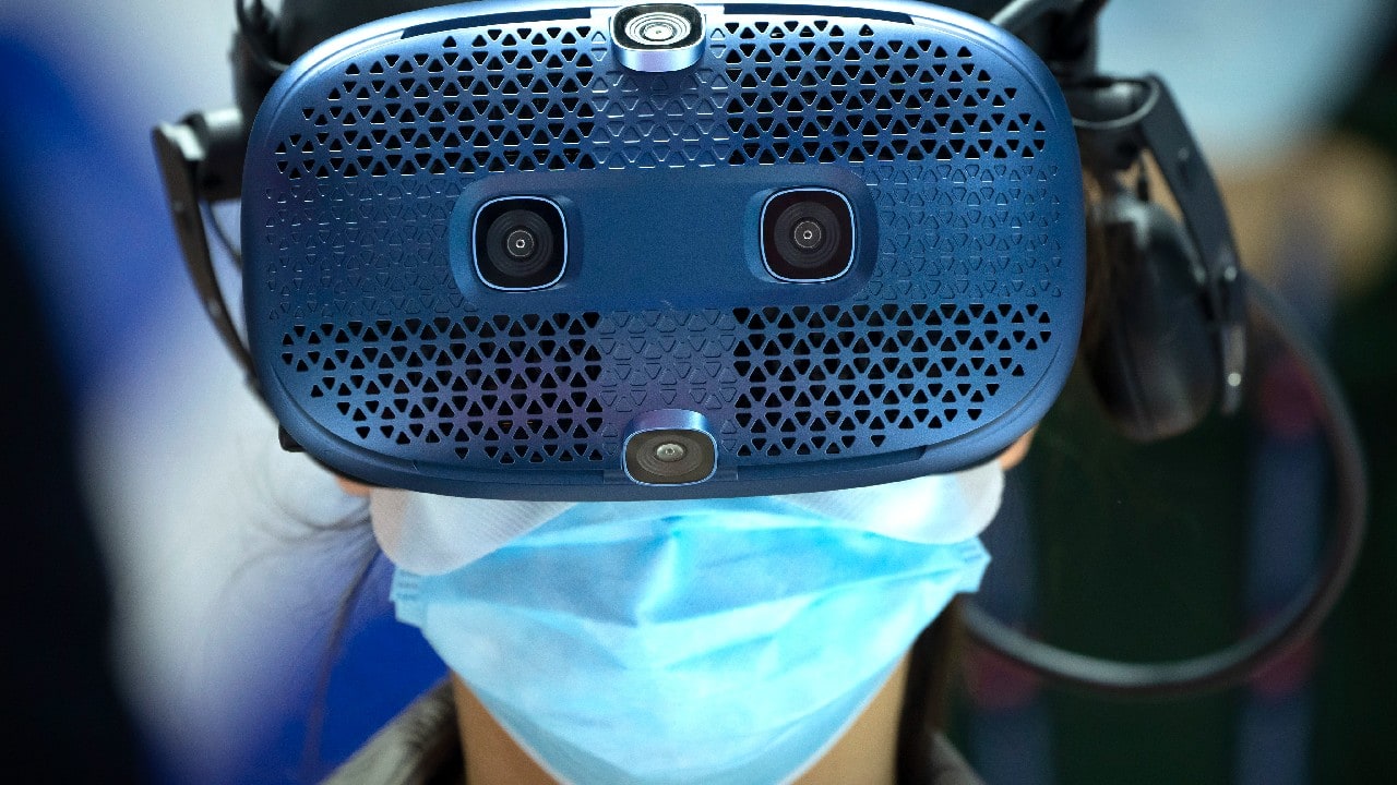 A woman wears a virtual reality headset as she takes a simulated bobsleigh ride at a booth for Chinese telecom provider China Unicom at the PT Expo in Beijing, September 28. The annual expo showcases Chinese and foreign telecommunications firms. (Image: AP)